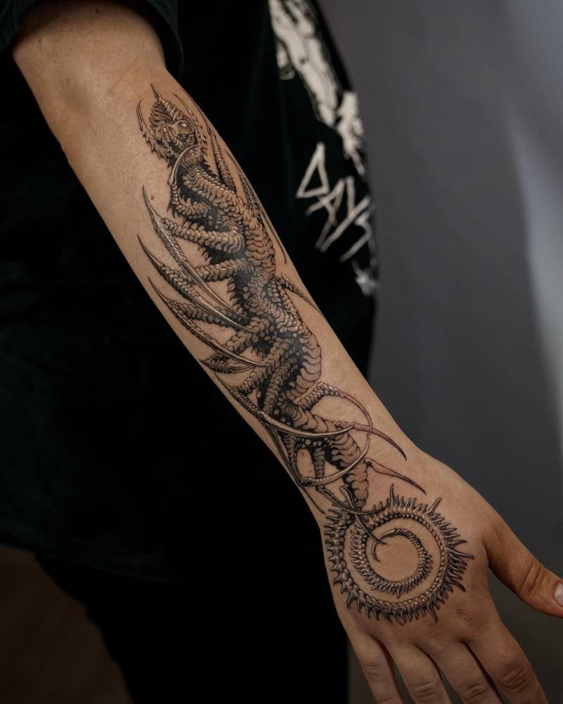 Monster tattoo in comic style located on the forearm.