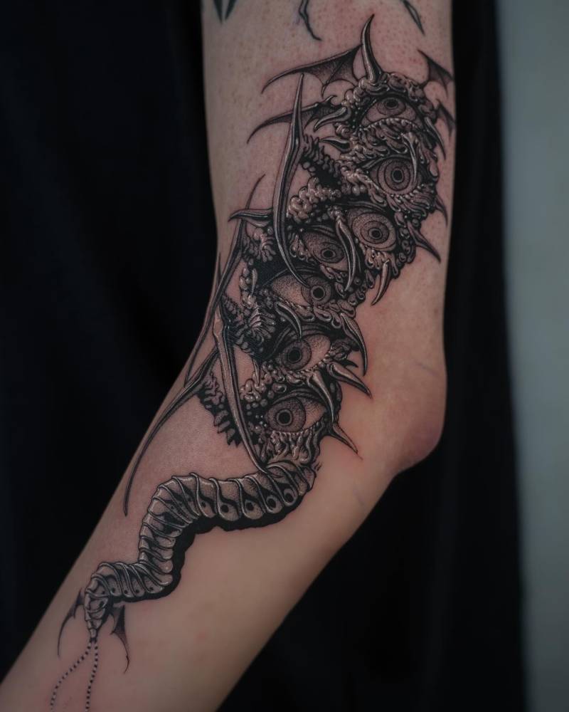 Monster tattoo placed on the arm, done in comic style.