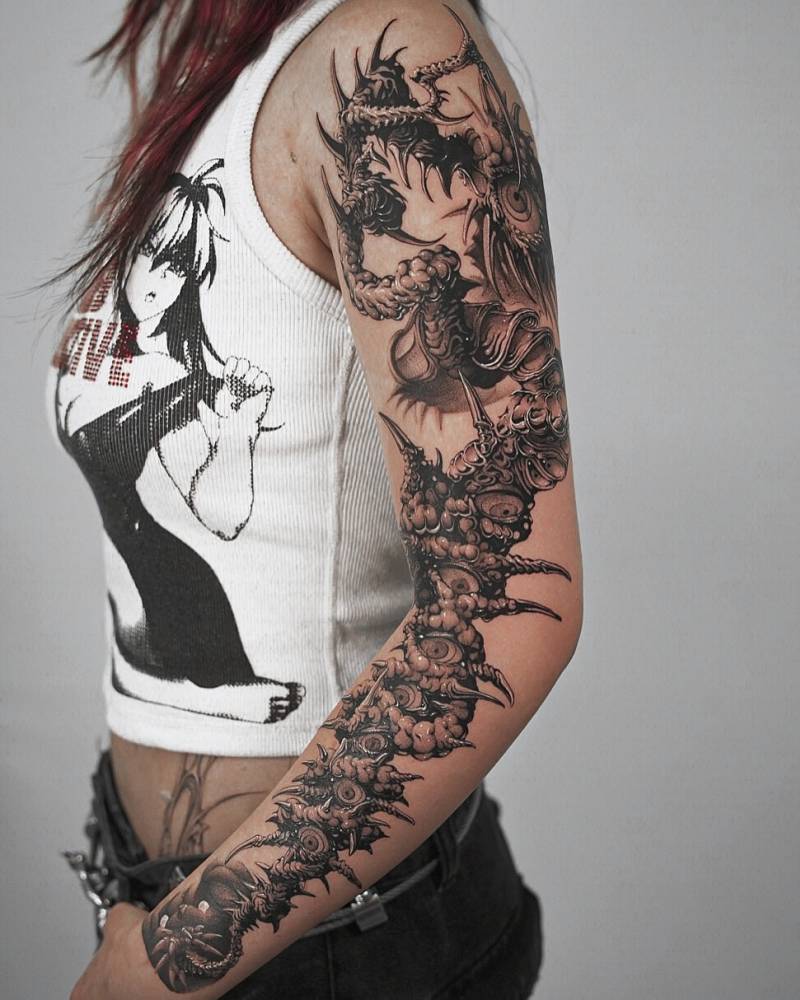 Comic style monster tattoo located on the arm.