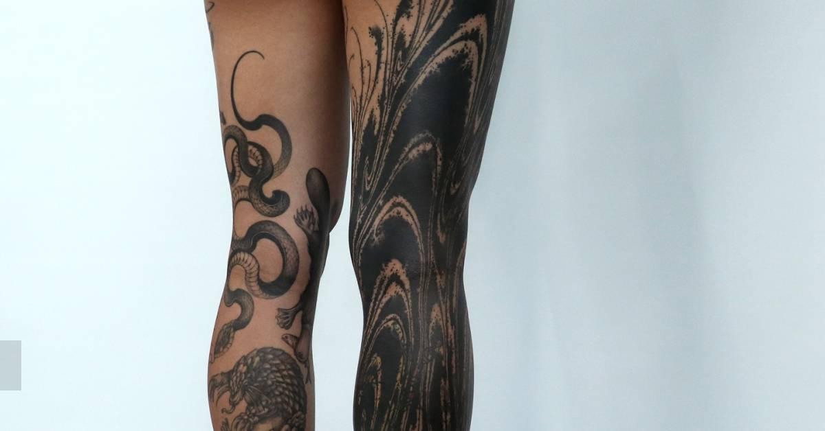 Abstract leg sleeve tattoo in blackwork style.