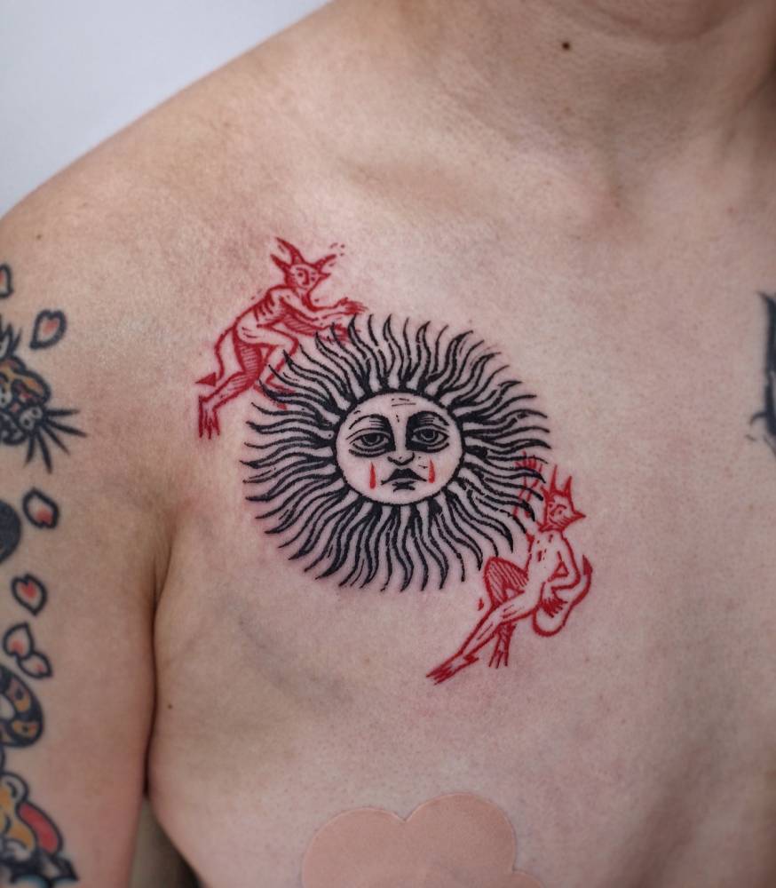 Inti sun and devils tattoo located on the chest, engraving style.