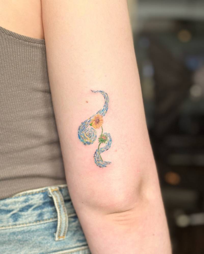 Abstract 'The Starry Night' and sunflower tattoo located on the tricep.