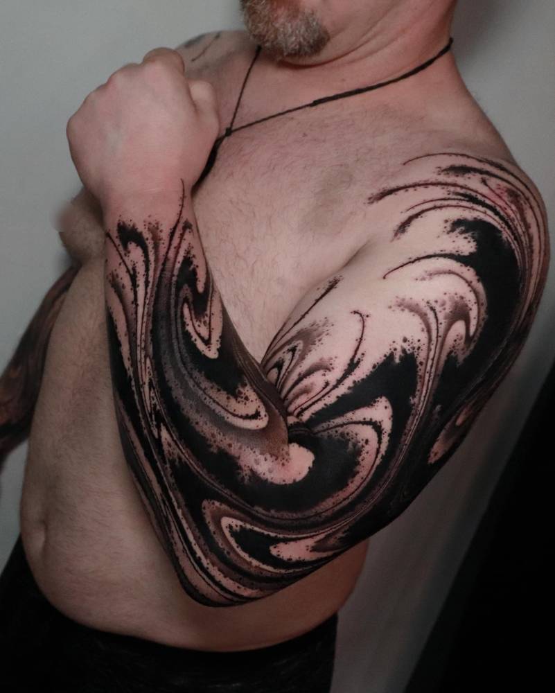 Abstract flow tattoo sleeve in blackwork style.