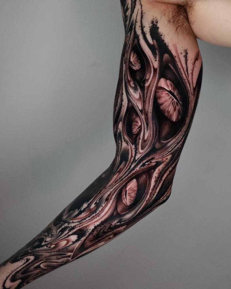 Abstract eyes tattoo sleeve in black and grey style.