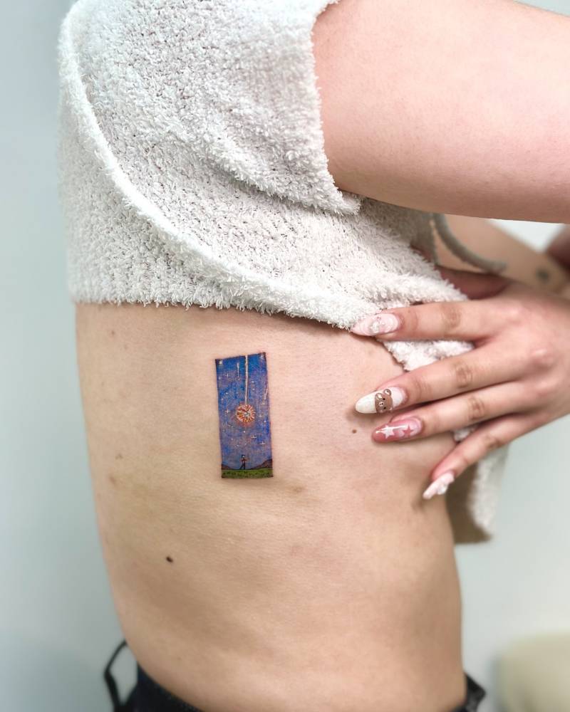 Howl's Moving Castle tattoo located on the side boob, cartoon style.