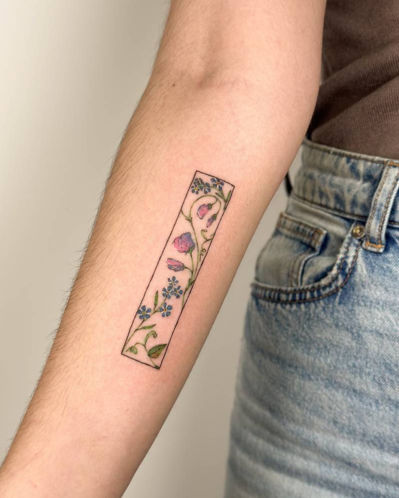 Floral collection tattoo located on the inner forearm, watercolor style.