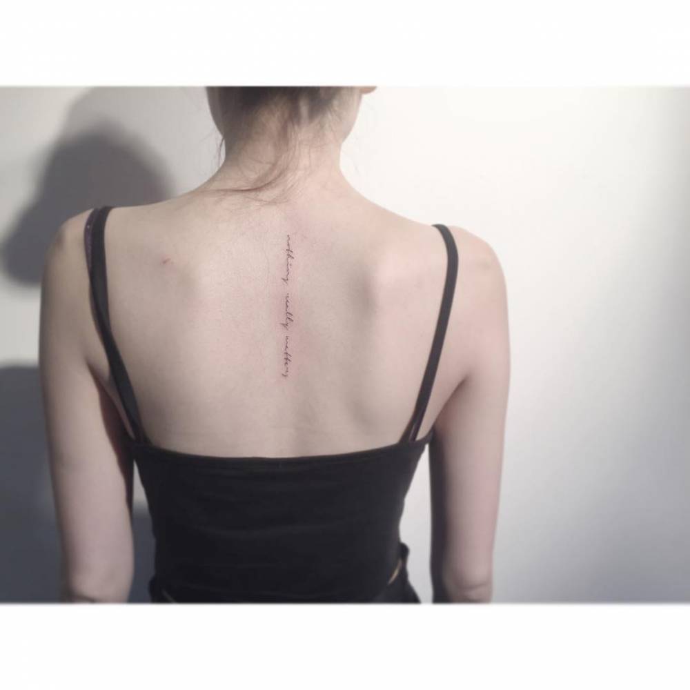 "Nothing really matters" lettering tattoo located on the upper back.