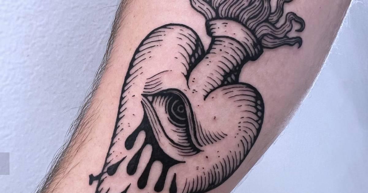 Crying flaming heart tattoo in engraving style done on