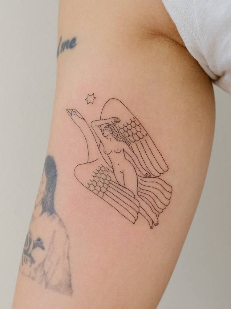 Robert Garrison's artwork 'Morning, Present, Evening' tattooed on the inner arm.