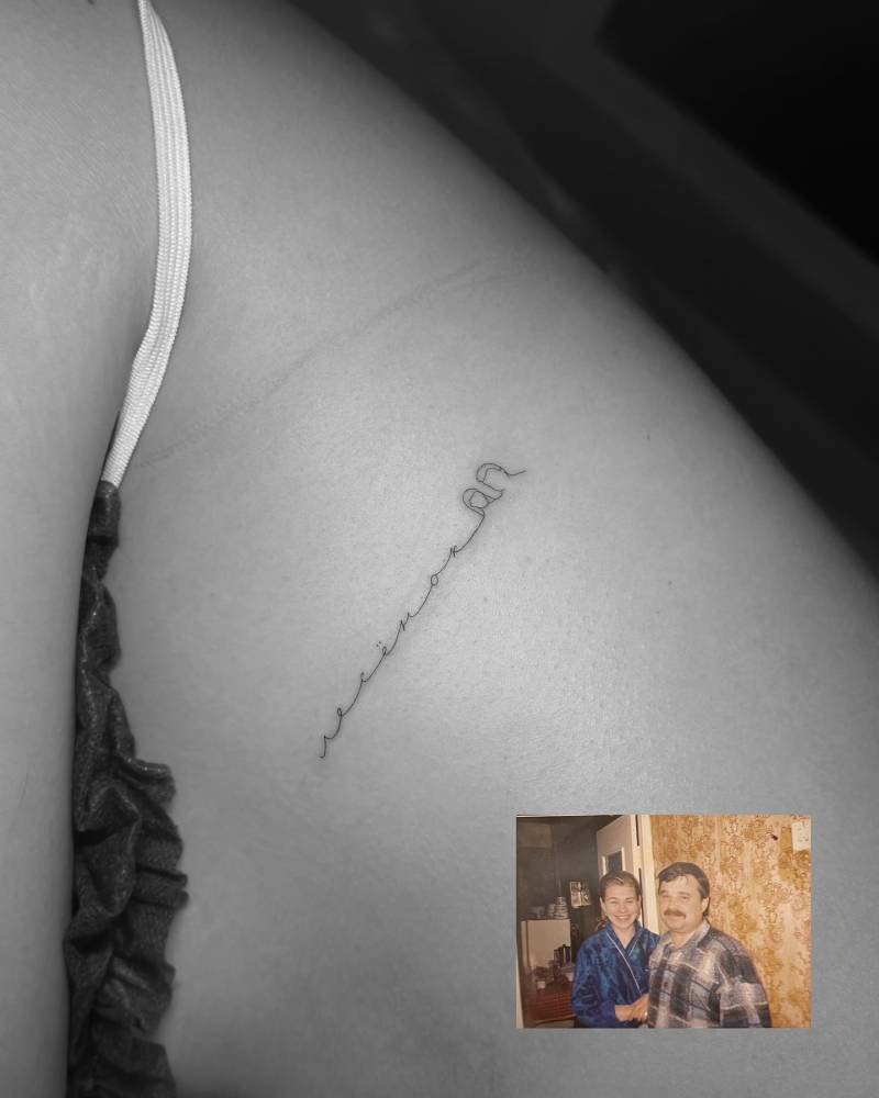 Handwritten lettering and minimalistic portrait tattooed on the side boob.