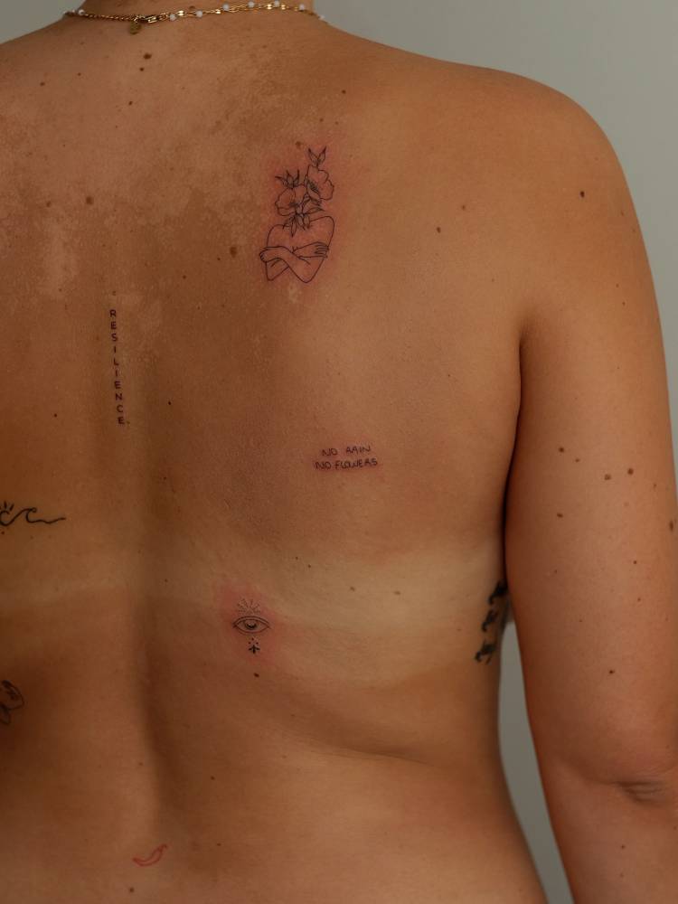 Back composition tattoo in fine line style.