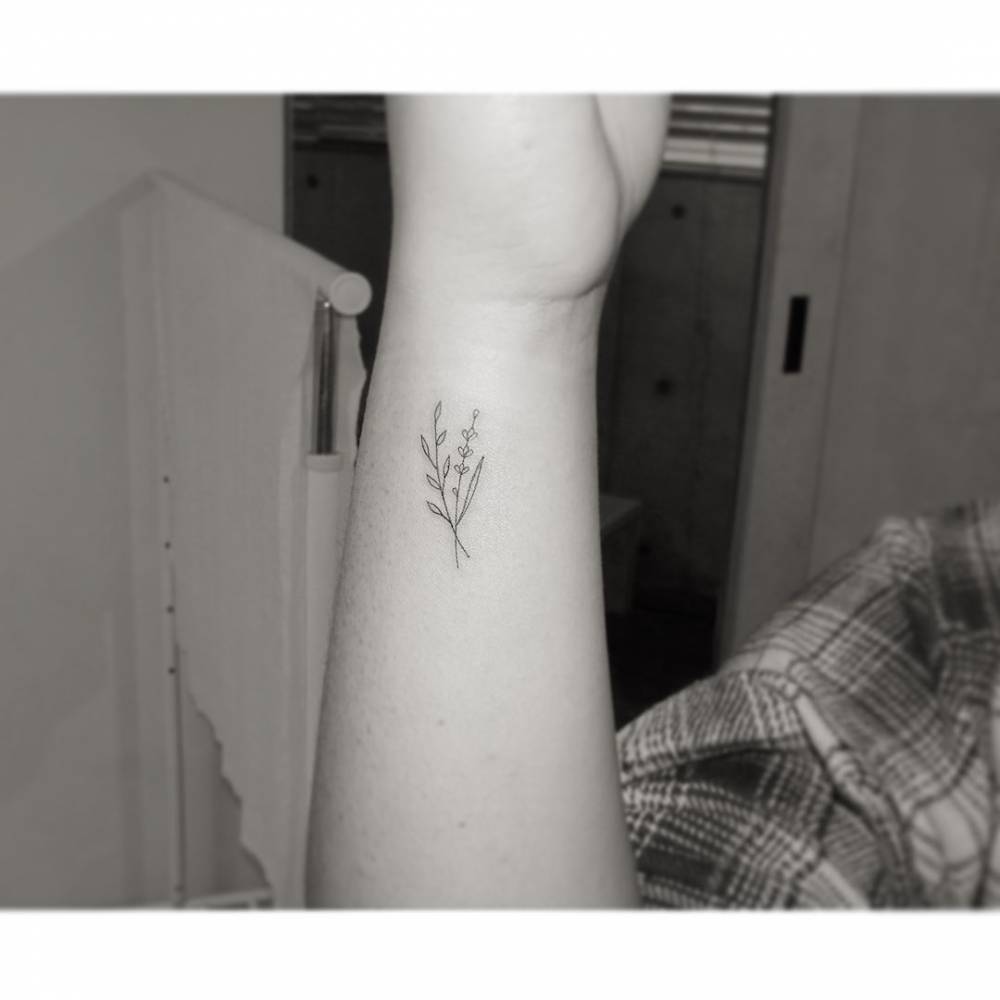 Lavender tattoo in minimalistic style located on the inner forearm.