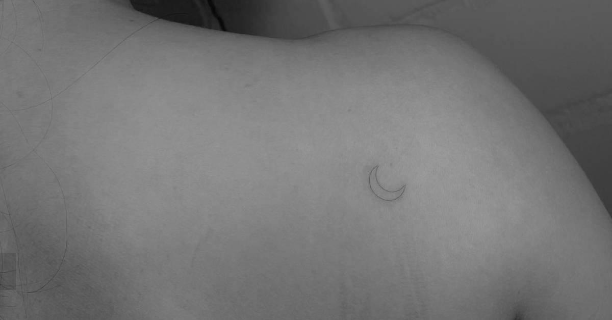 Fine line style crescent moon tattoo done on the