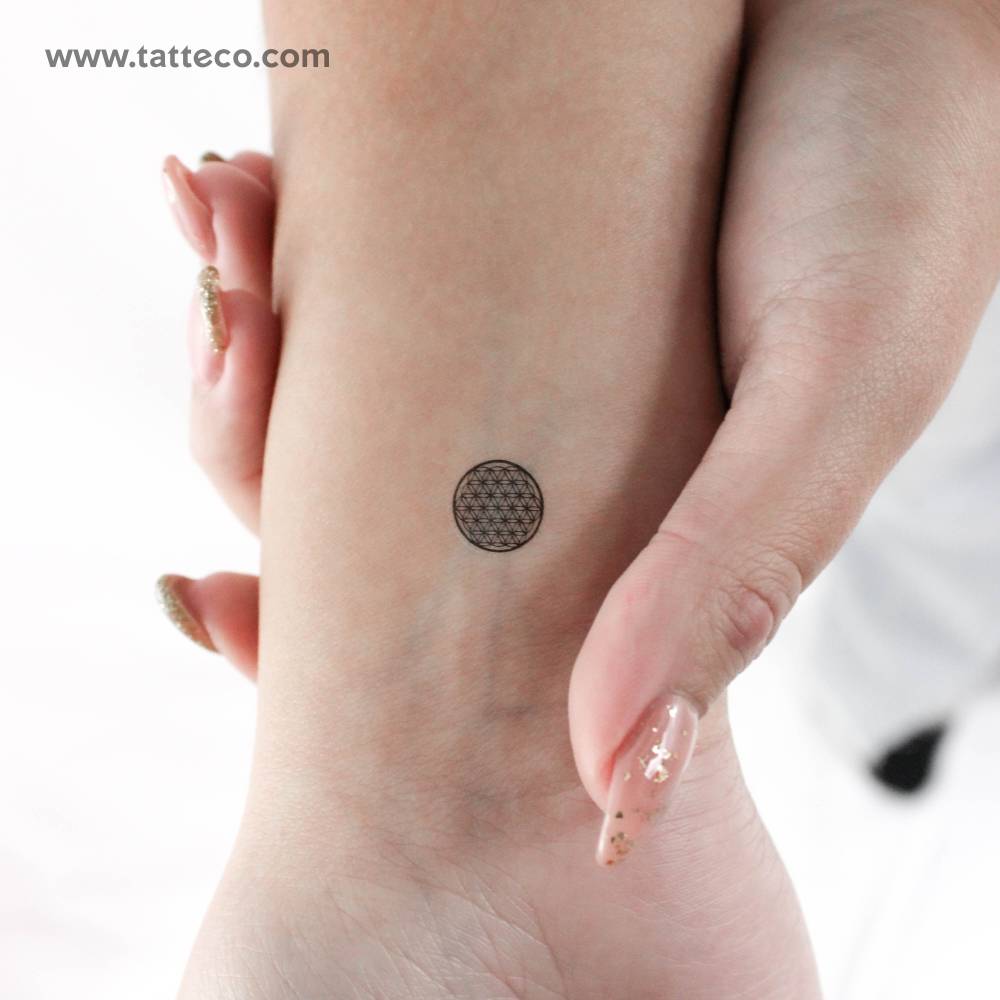 Tiny flower of life temporary tattoo located on the wrist.