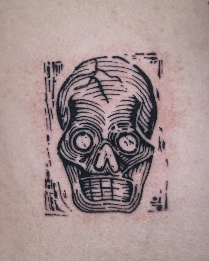 Engraving style skull tattoo placed on the rib.