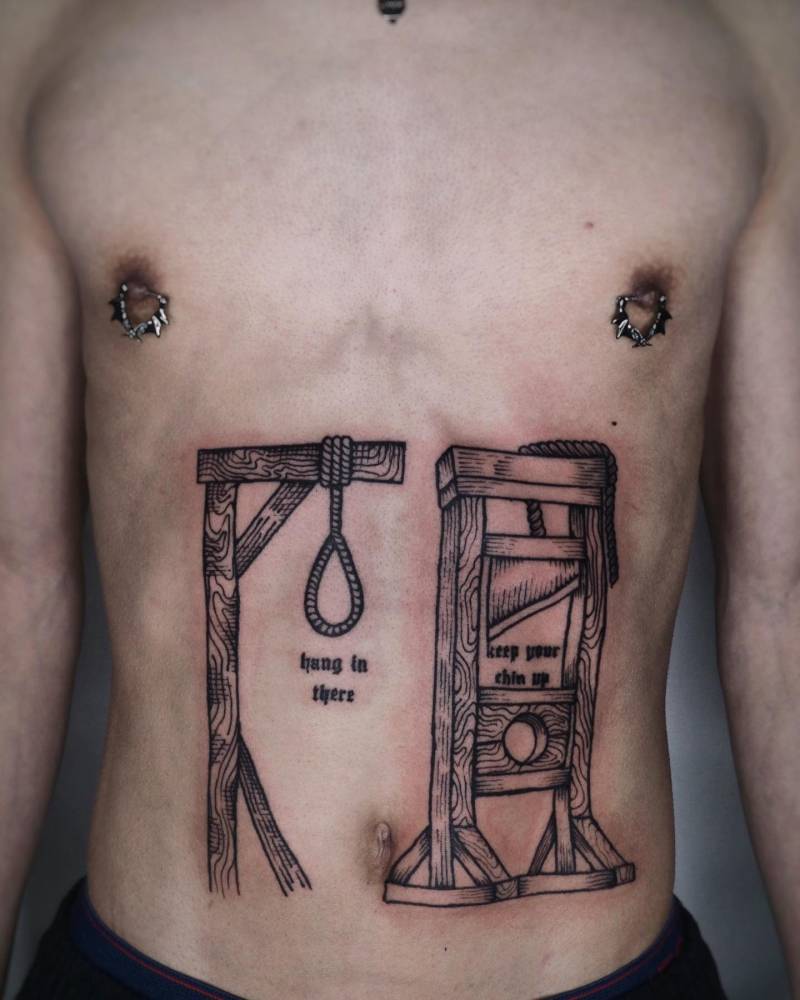 Guillotine and gallows tattoo located on the stomach, engraving style.