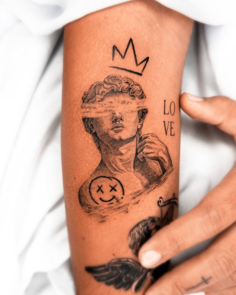 Pop art style Michelangelo's 'David' tattoo located on the inner forearm.