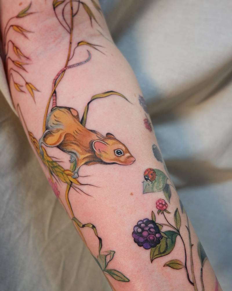 Neotraditional style mouse tattoo located on the inner forearm.