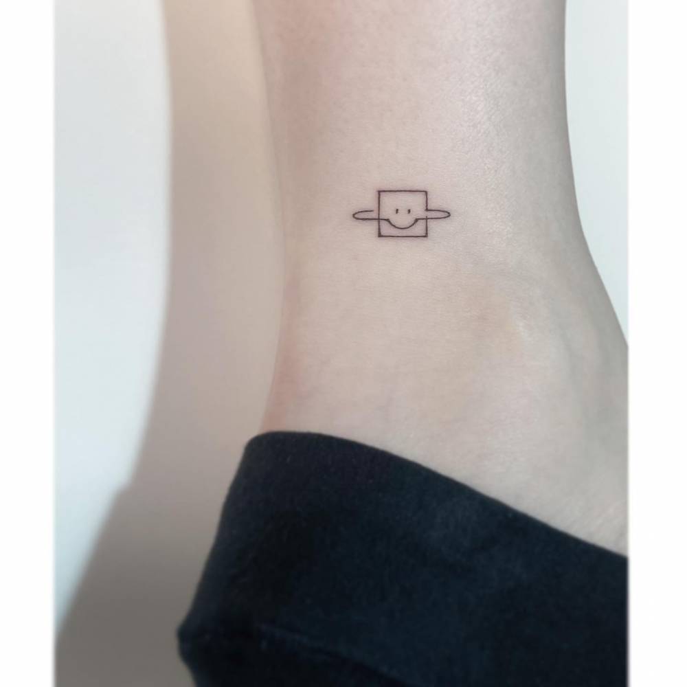 Square Saturn tattoo in minimalistic style located on the ankle.
