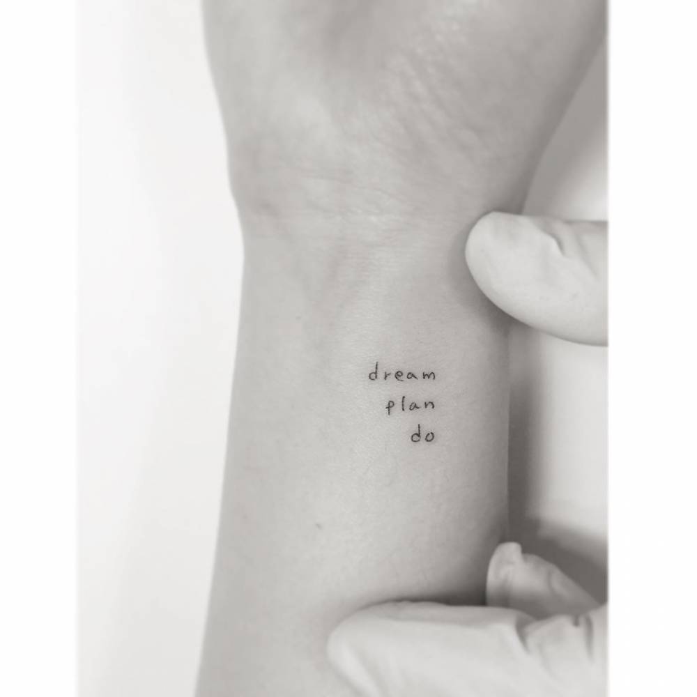 "Dream, plan, do" lettering tattoo in handwritten font.