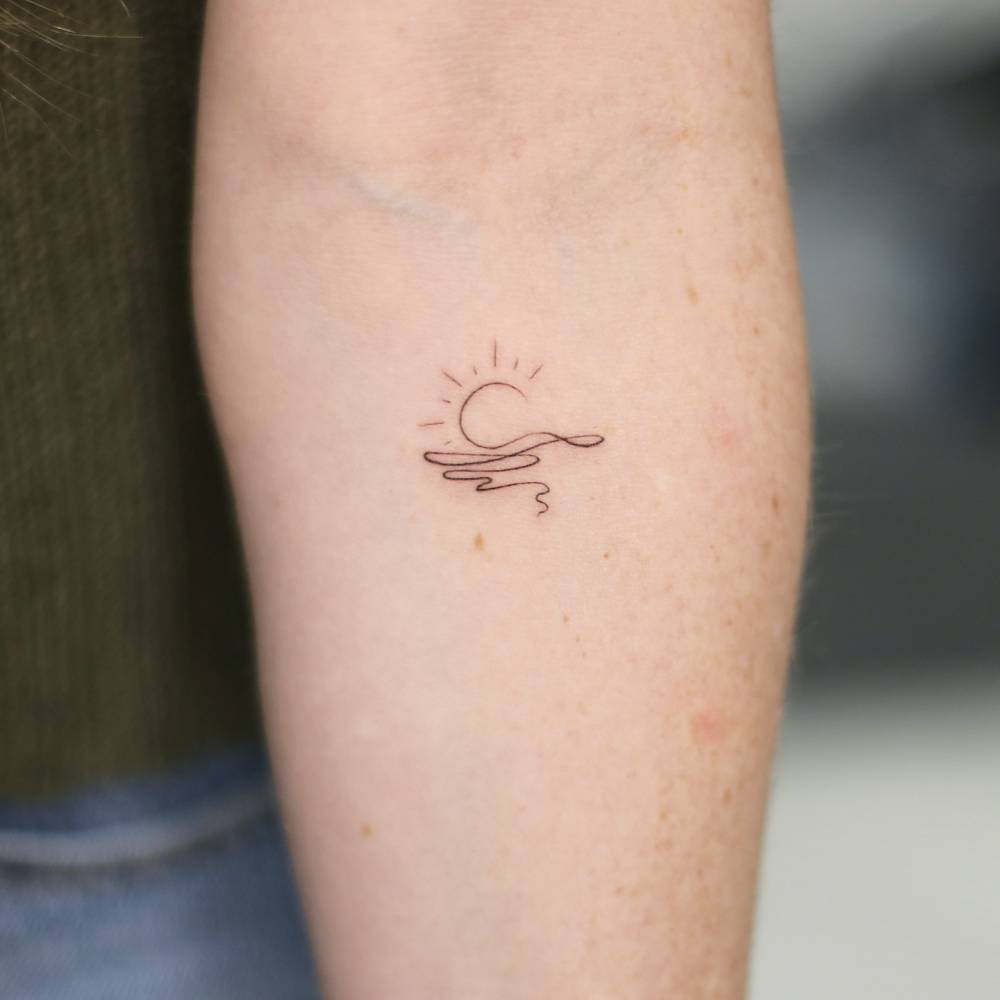Continuous line sea sunset tattoo located on the inner forearm.