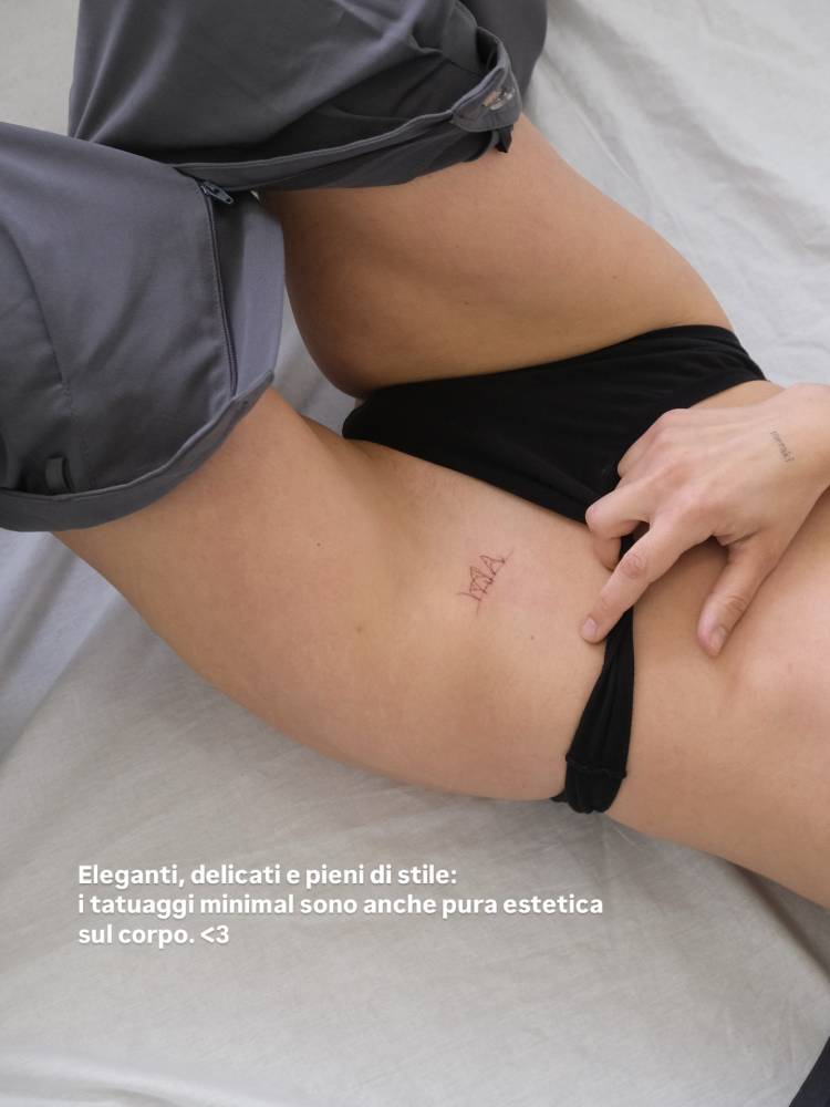 Clothes line tattoo in fine line style done on the pelvis.