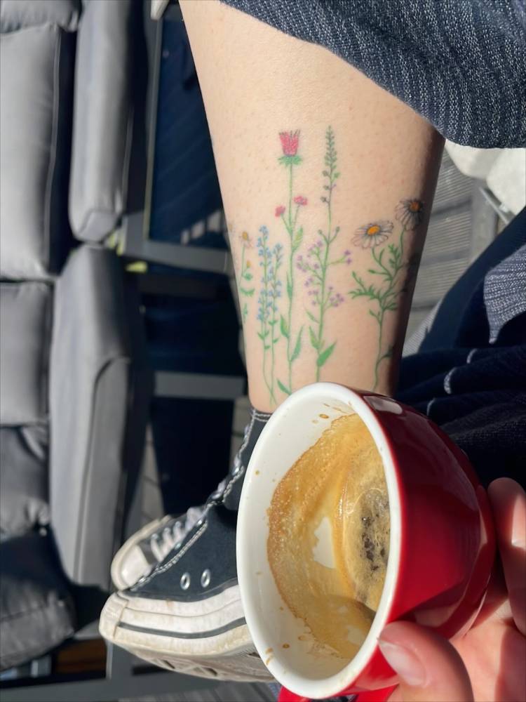 Healed floral collection tattoo located on the ankle.