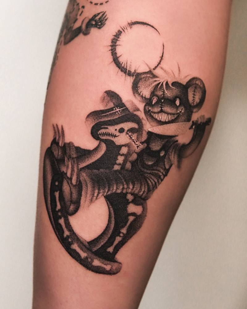 Teddy bear and rocking horse tattoo located on the calf.