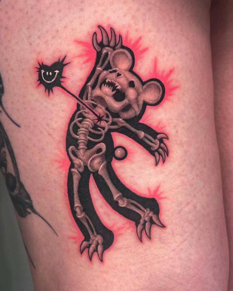 X-ray teddy bear tattoo located on the thigh.