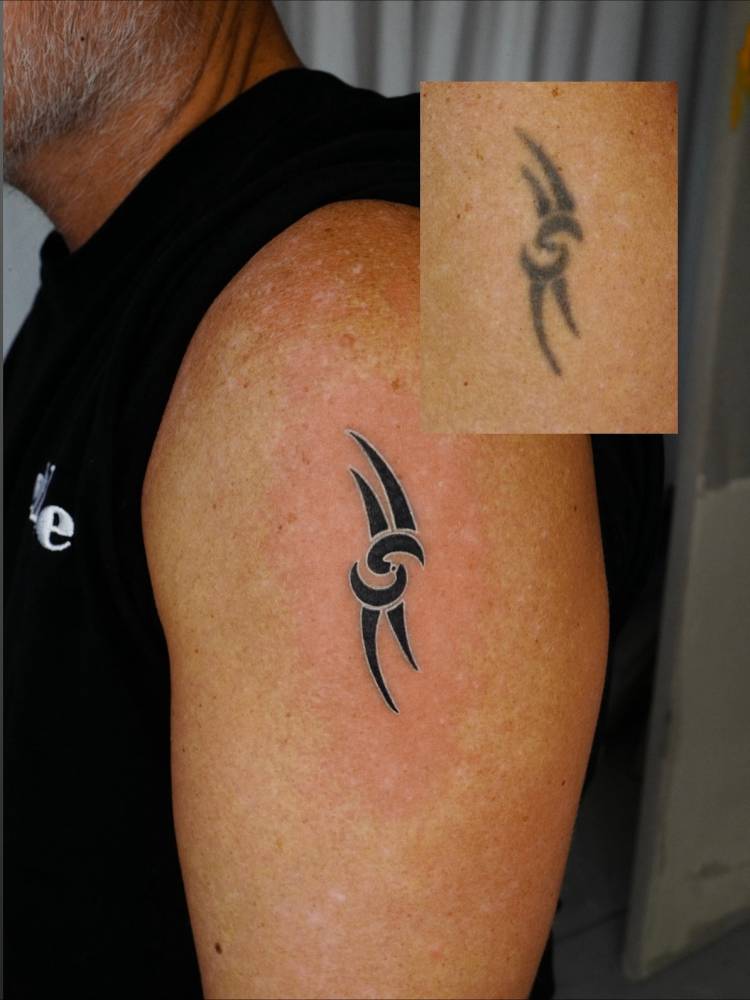 Touch up reviving an old tribal tattoo.