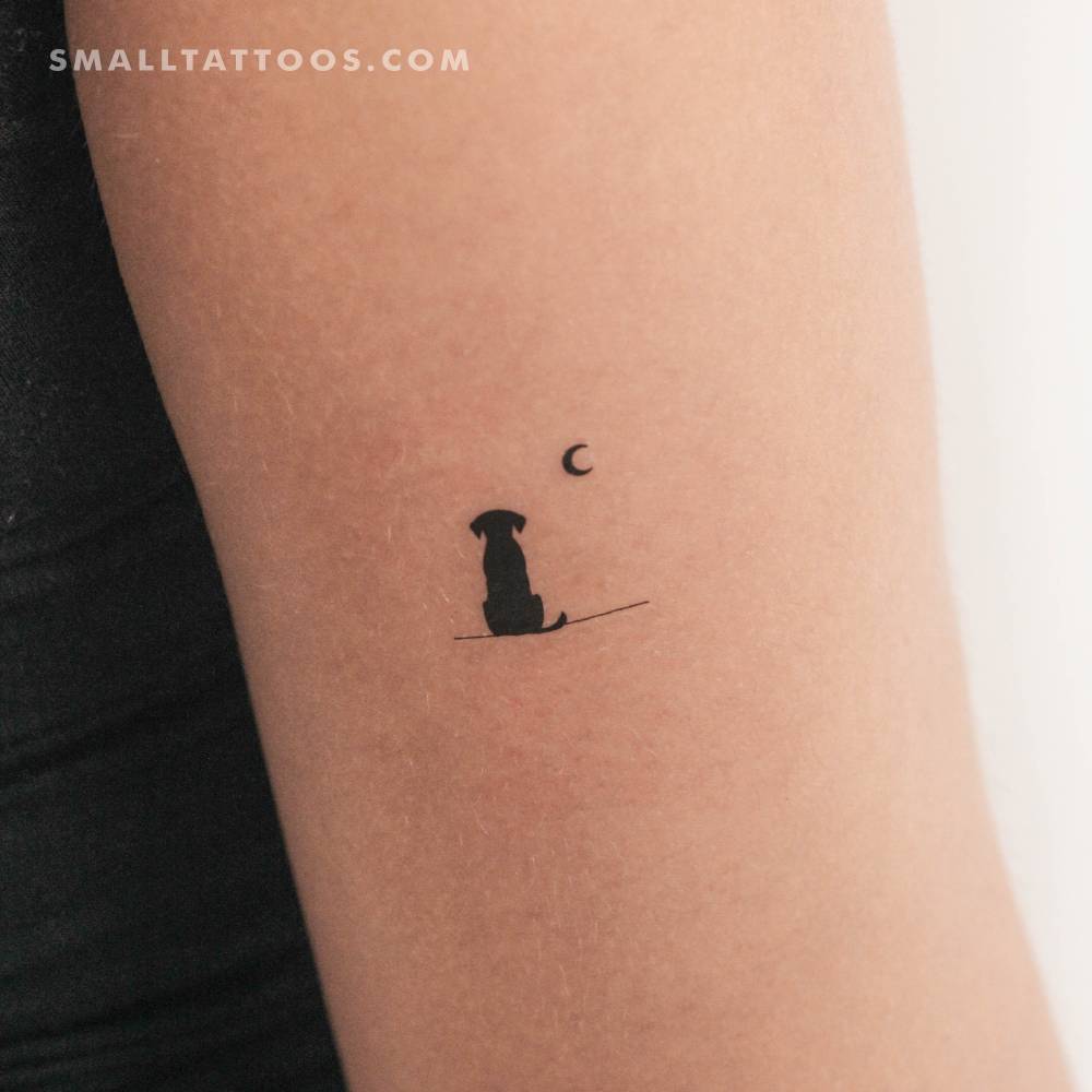 Dog looking at the moon temporary tattoo located on the tricep.