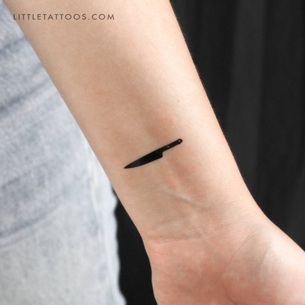 Black chef knife temporary tattoo located on the wrist.