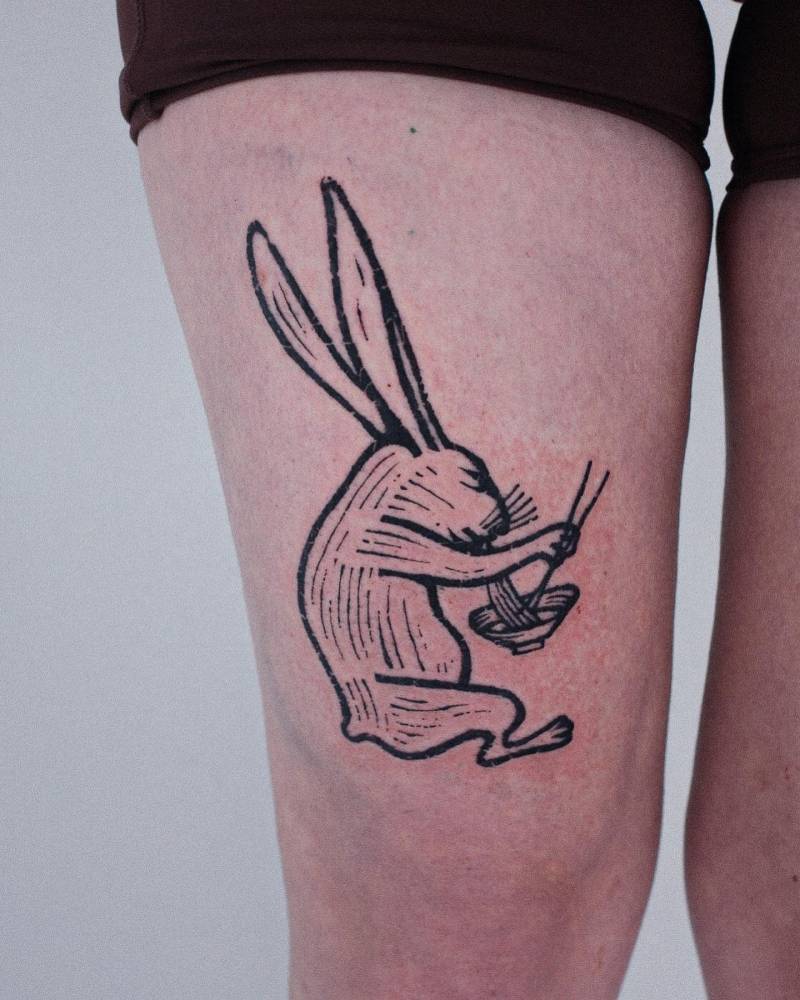 Engraving style hare tattoo located on the thigh.