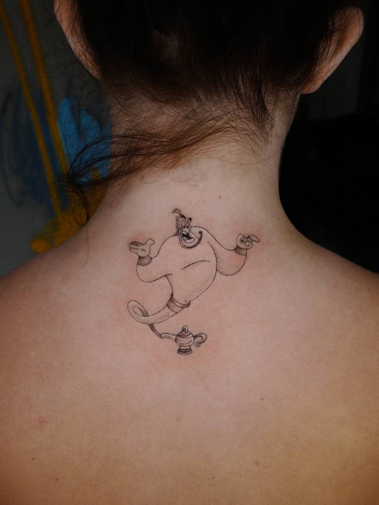 Genie tattoo in cartoon style placed on the upper back.