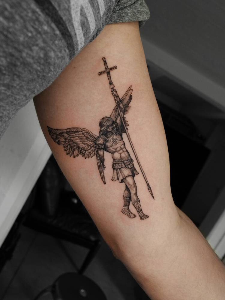 Archangel Michael tattoo in illustrative style located on the inner arm.