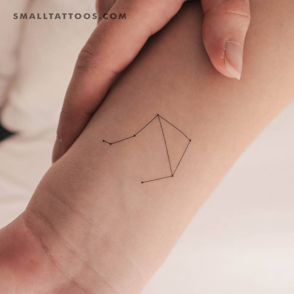 Small Libra constellation temporary tattoo located on the wrist.