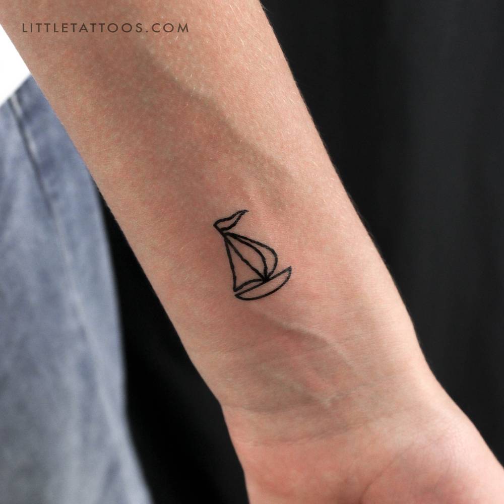Minimalistic style sailboat temporary tattoo located on the wrist.