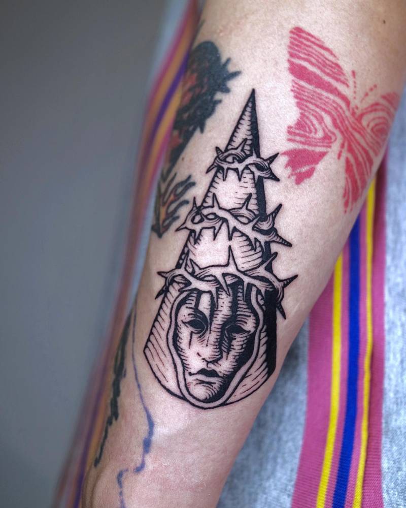 Penitent One from 'Blasphemous' tattooed on the inner forearm.