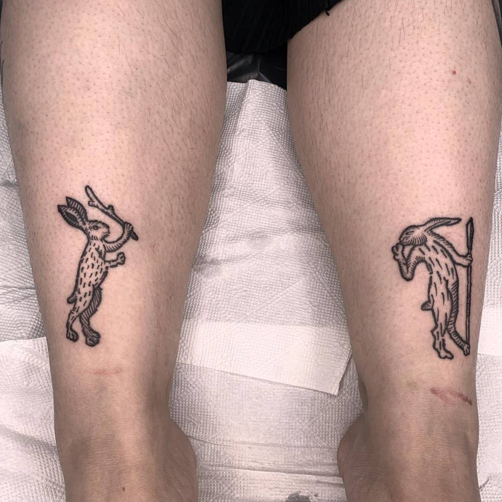 Individual matching hares tattooed on the achilles, blackwork style.