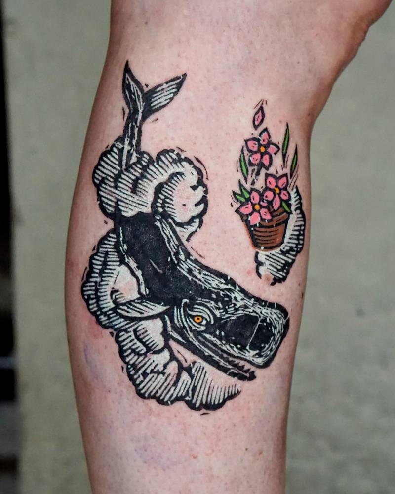 The Hitchhiker's Guide to the Galaxy tattoo located on the calf.