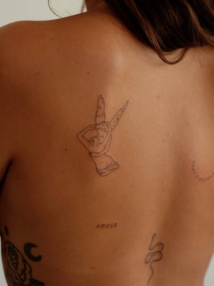 'Psyche Revived by Cupid's Kiss' tattoo in fine line style, done on the shoulder blade.