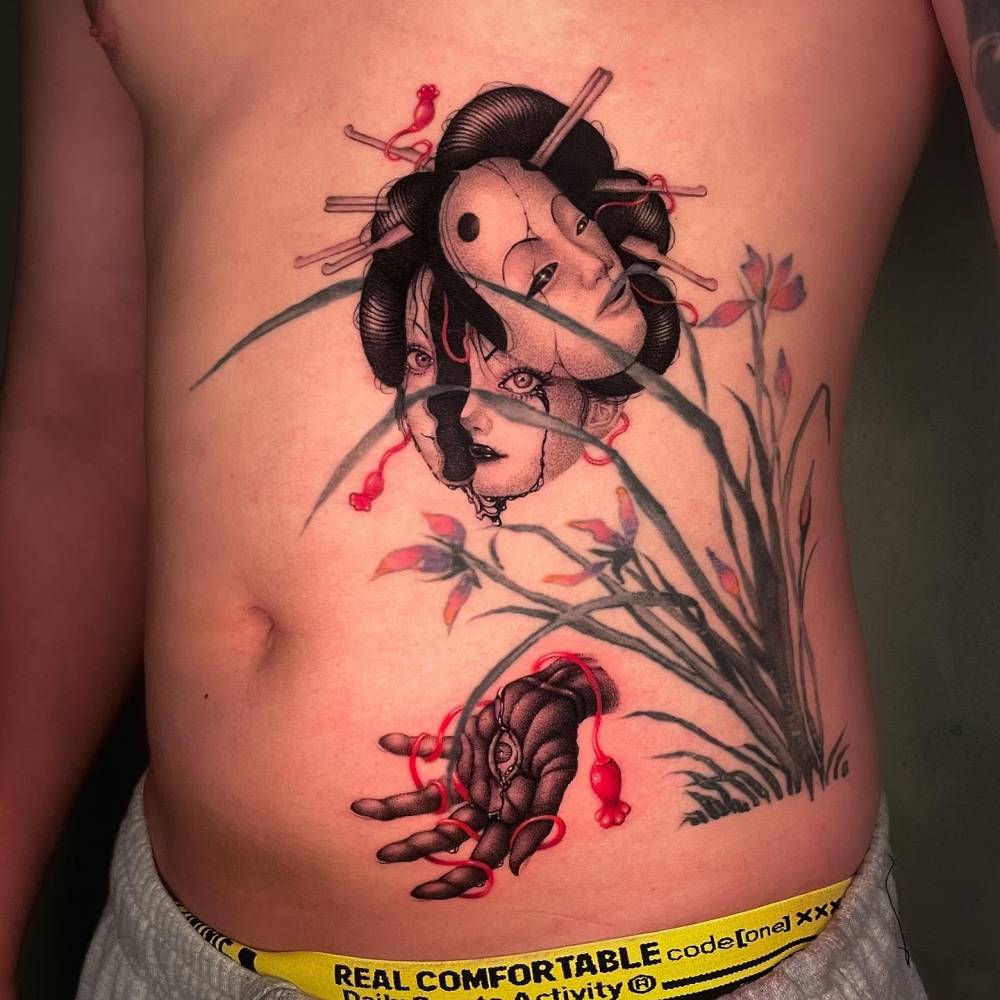 Geisha and hand tattoo located on the rib and waist.