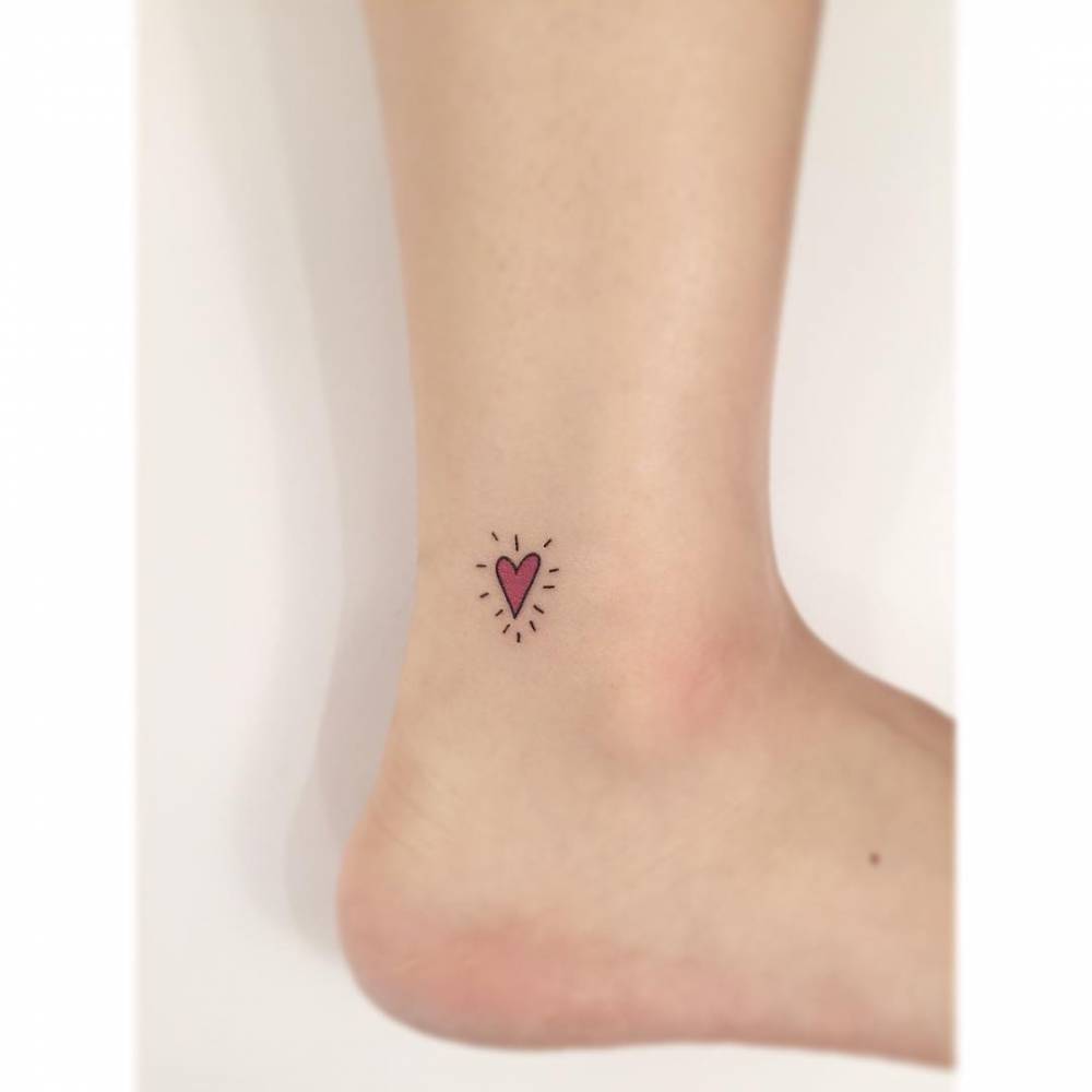 Tiny heart tattoo located on the ankle.