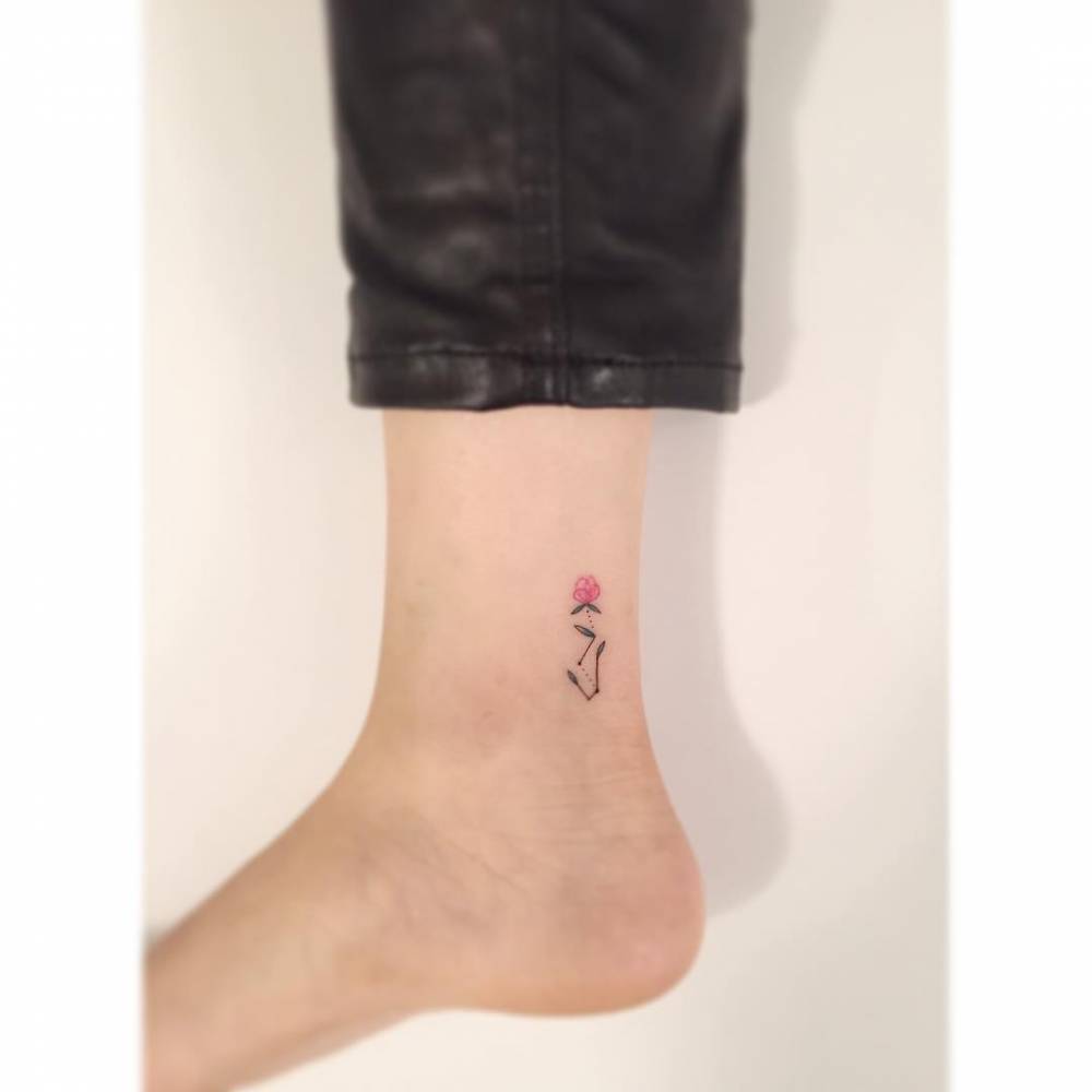 Scorpius constellation and flower tattoo located on the ankle, minimalistic style.