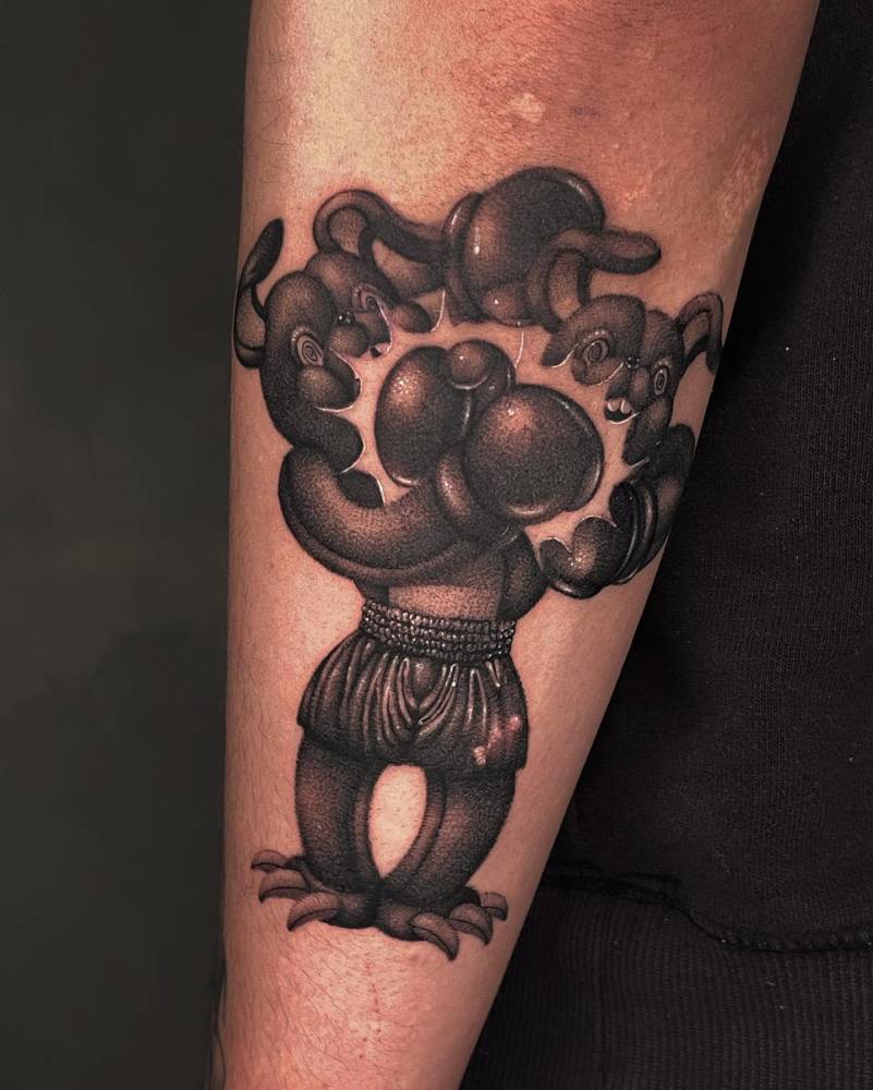 Dotwork style boxing teddy bear tattoo located on the forearm.