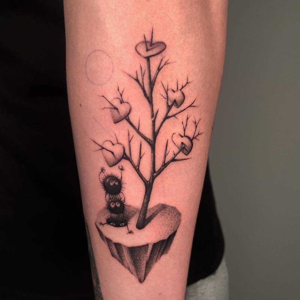 Leafless tree, Soot Sprites and hearts tattooed on the forearm.