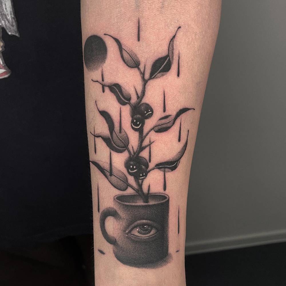 Surrealistic coffee cup and coffee plant tattoo located on the inner forearm.