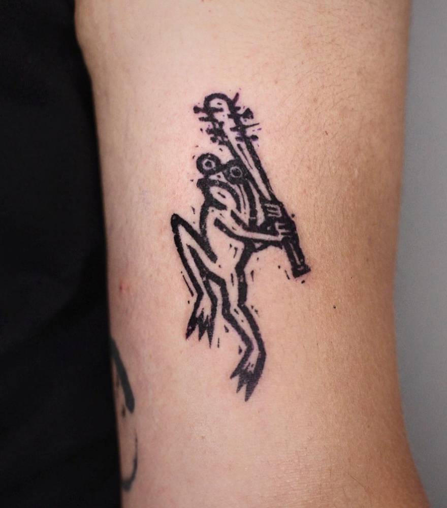 Frog with a bat tattoo located on the bicep, pop art style.