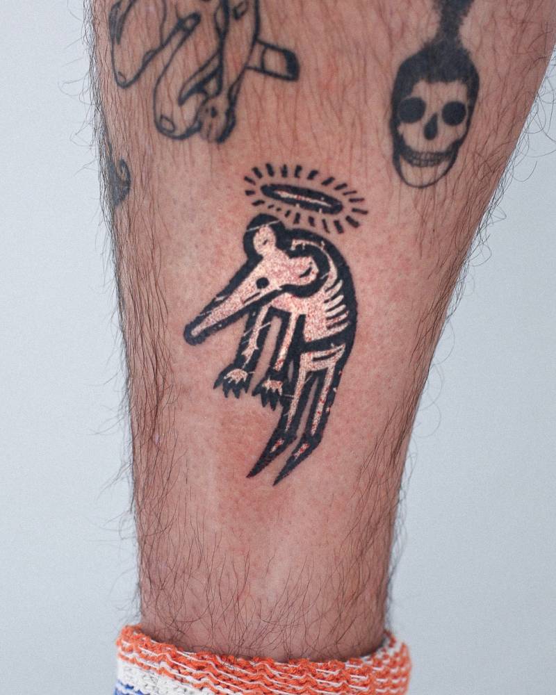 Pop art style rat with a halo tattooed on the shin.