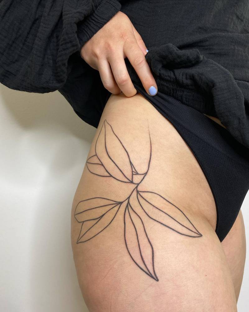 Hand poked leaves tattoo placed on the hip.